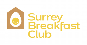 The Surrey Breakfast Club logo with mustard yellow text and a white background. Beside the words is a house with an egg inside.