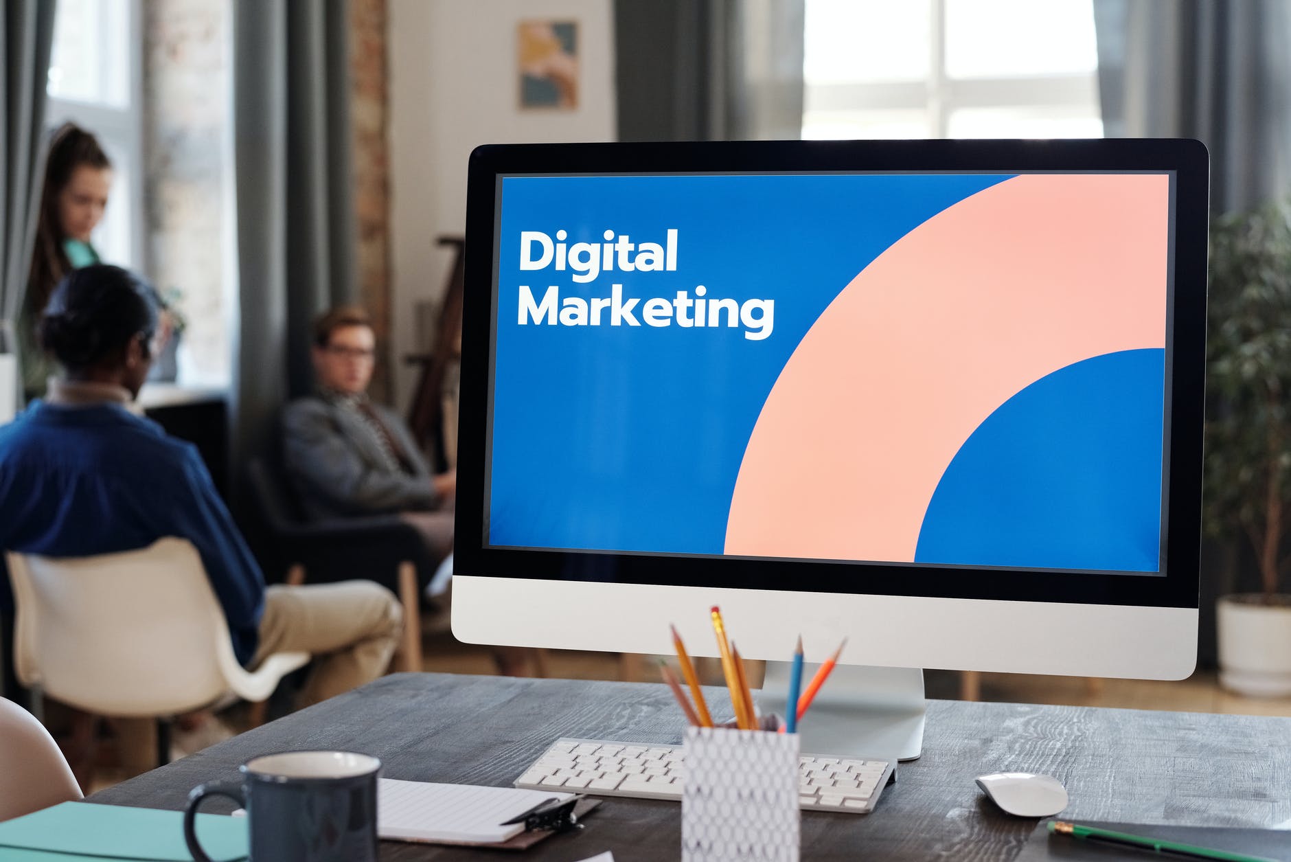 Image of an iMac on a desk, with &quot;Digital Marketing&quot; on the screen