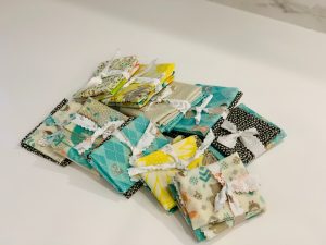 Photo of packets of beeswax food wraps made from organic cotton and available in beautiful colours like yellow and turquoise.