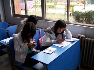 Students using cell phones in a classroom.