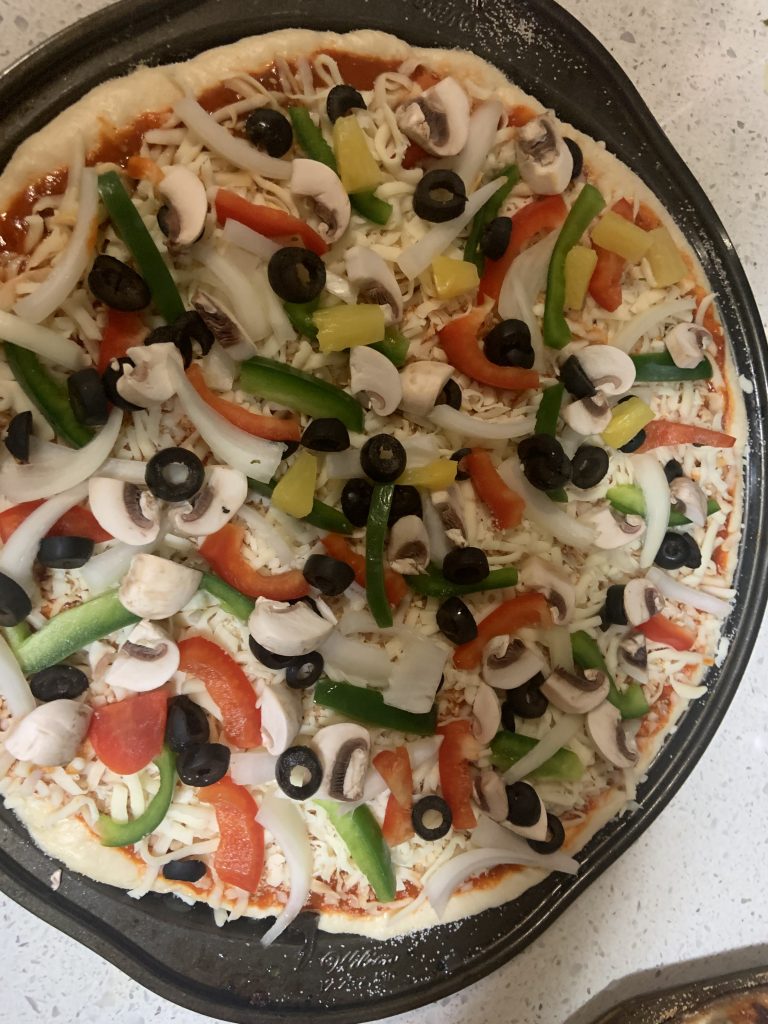 Unbaked pizza with toppings.