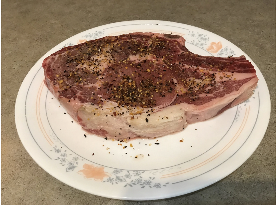 A seasoned steak on a plate