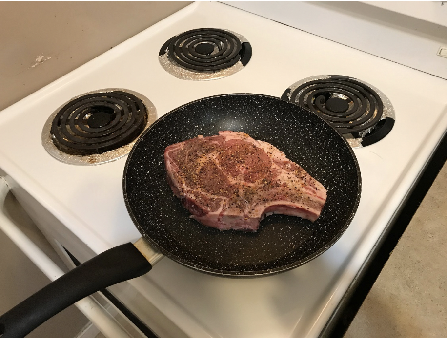 The steak cooking in a pan