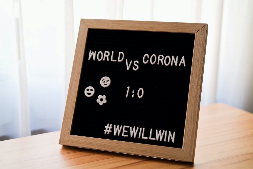 A chalkboard with the words world vs corona we will win written on it.