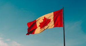 Canadian flag against a blue sky