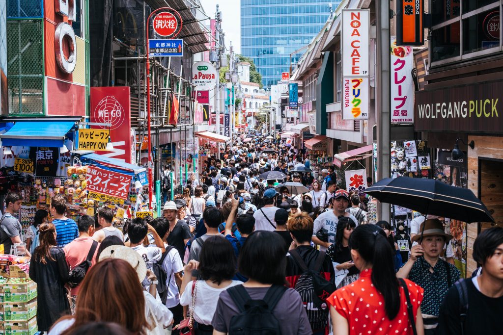Image of a very crowded street in a metropolitan urban centre somewhere in the world.