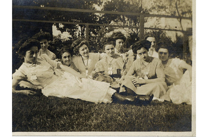 Photograph of a group of women lying on the grass, Beausejour, 1911