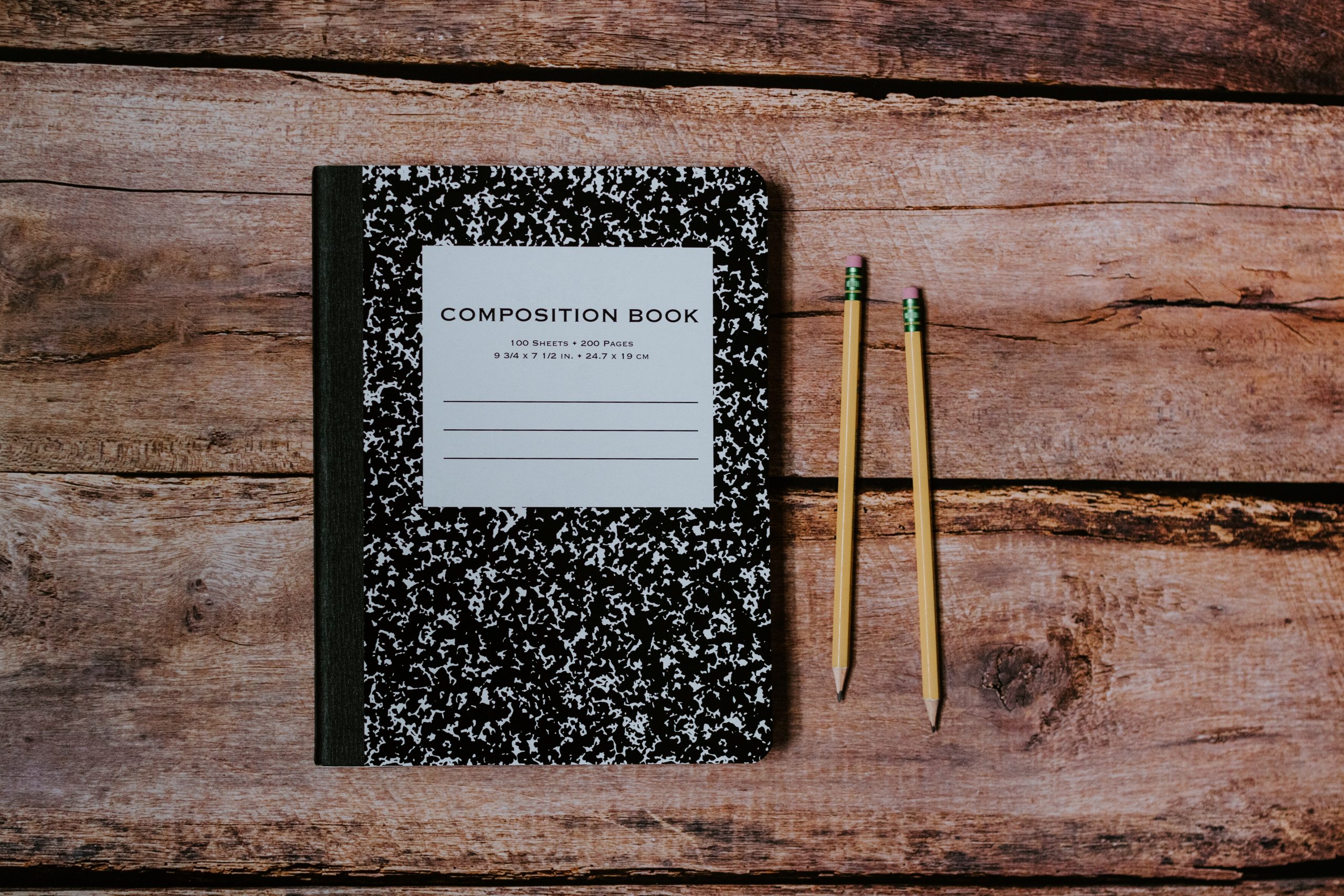 picture of notebook with pencils beside it