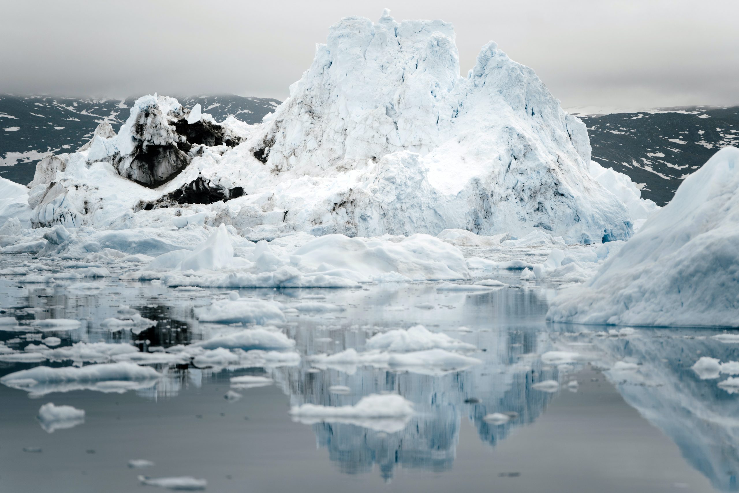 image of a large melting ice cap surrounded by broken ice on a body of water