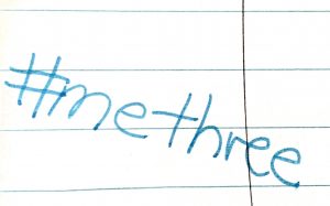 "Image contains a handwritten hashtag which reads #methree on a piece of ruled white paper."
