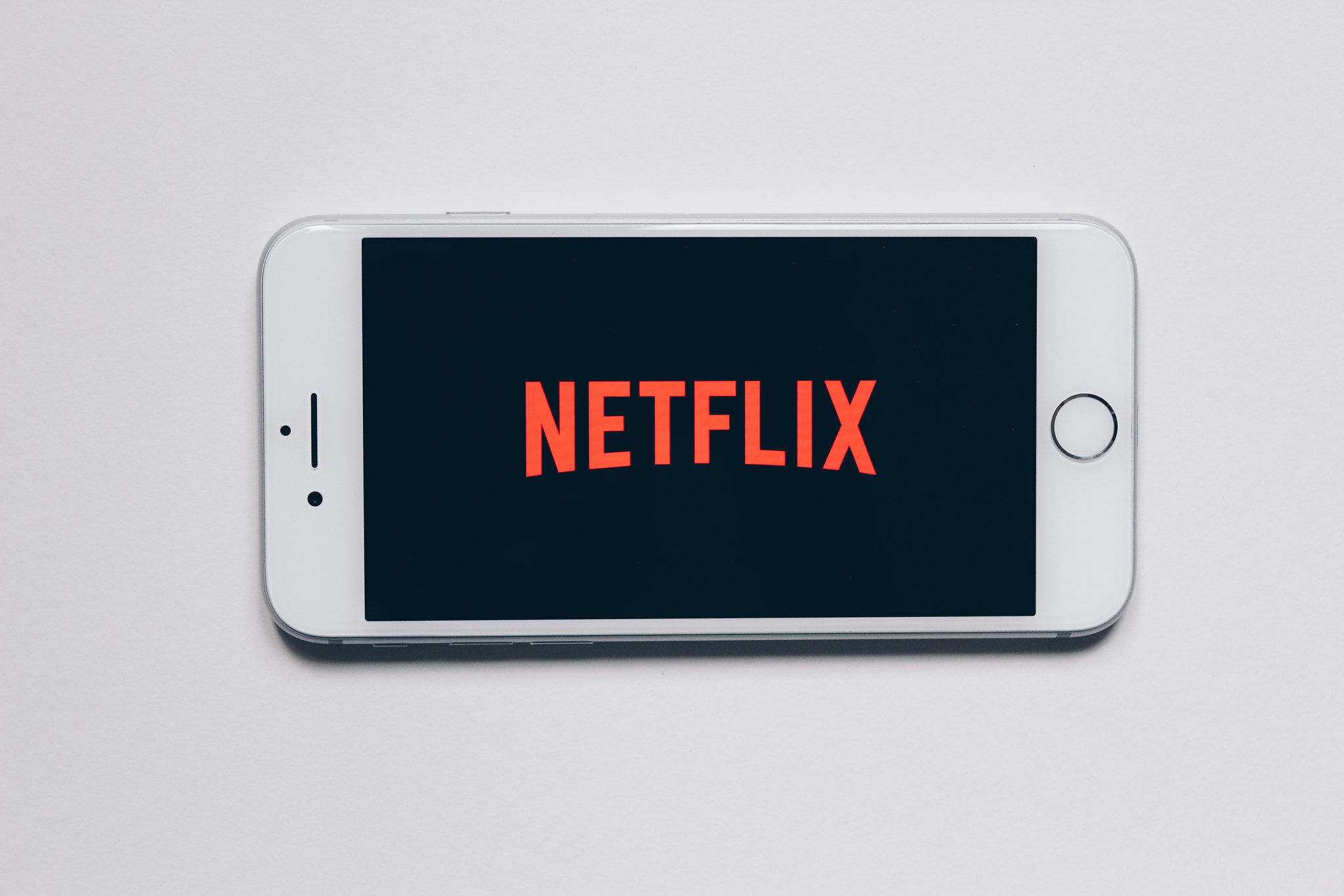 An iPhone with Netflix's loading screen.