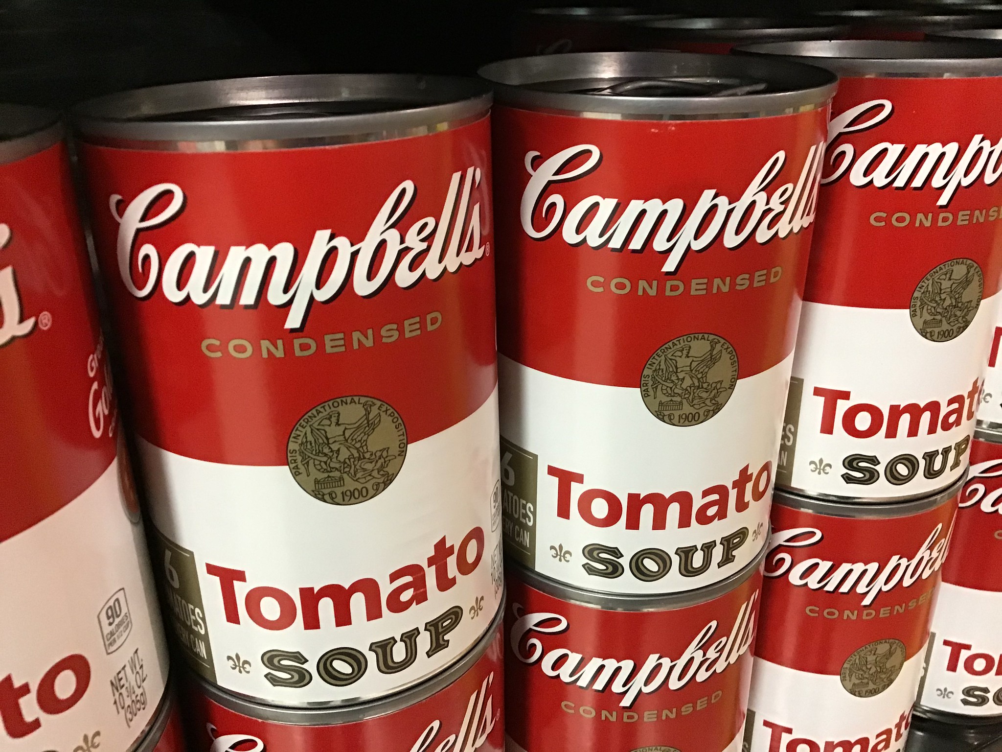 Campbell's Tomato Soup cans stacked on top of each other.