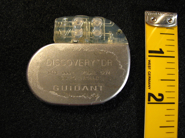 Pacemaker next to a ruler, showing it is no bigger than two inches.
