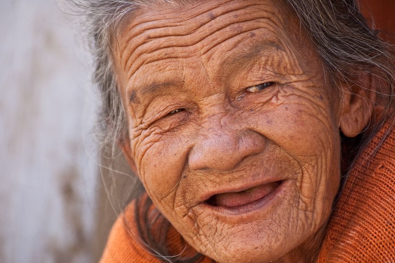 An old woman smiling.