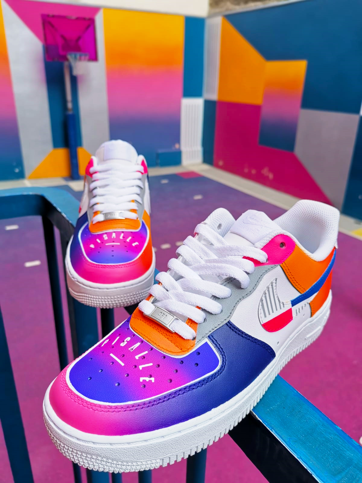 Nike Airforce 1 shoes in neon white, blue, pink and orange.