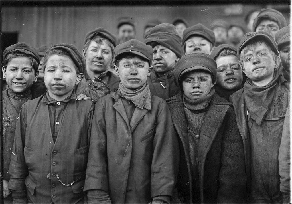 Black and white photo of child miners with soot on their faces