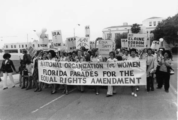 march of women holding a banner that reads national organization for women presents Florida parades for the equal rights amendment