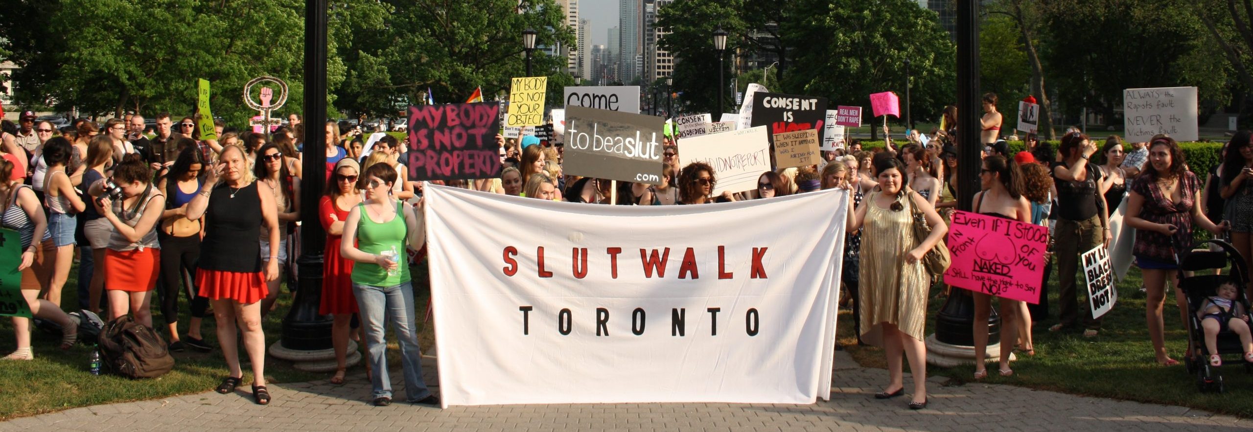Large group holding a Slut walk Toronto banner