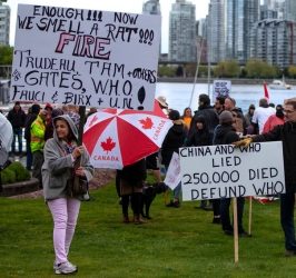 Protesters hold signs readingEnough we smell a rat. Fire Trudeau, Tam and Others