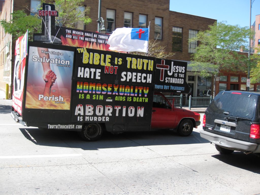 truck with signs that read the bible is truth not hate speech, homosexuality is a sin aids in death abortion is murder.