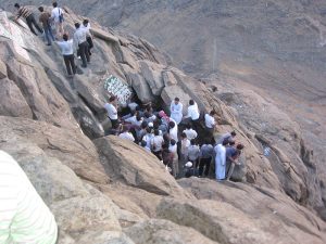 Image of people trying to enter a cave