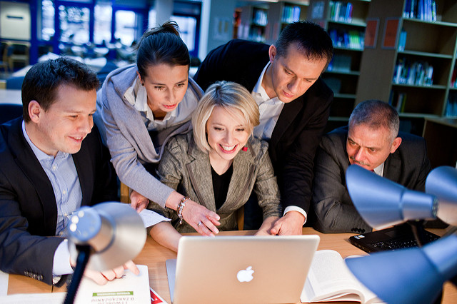 A group working on a project together on a computer