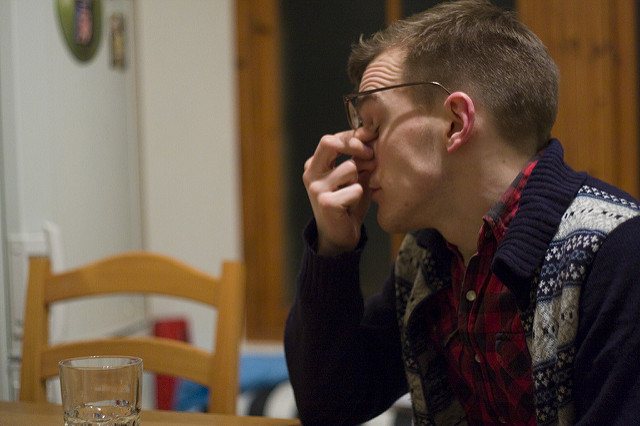 A man looking stressed out at the dinner table