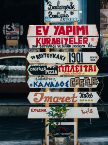 Various signs in different languages for restaurants and tourist attractions